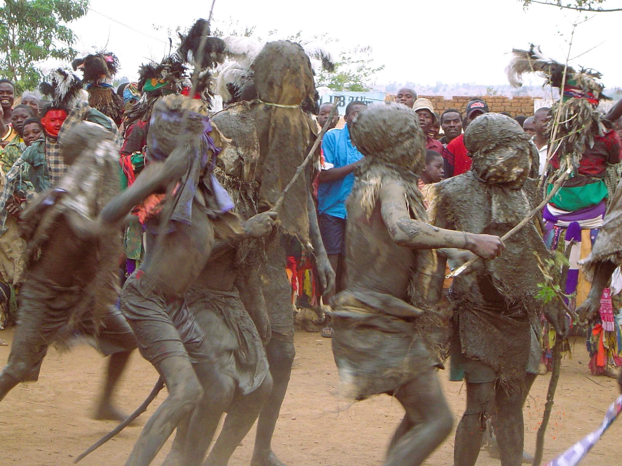 Mud-covered dancing African children